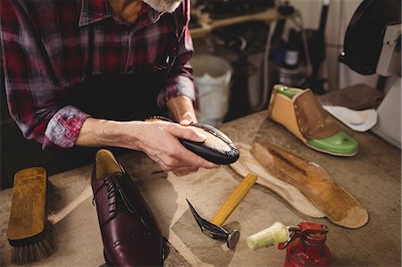 simsearch:6109-08582278,k - Cobbler holding a shoe Stock Photo - Premium Royalty-Free, Code: 6109-08582258