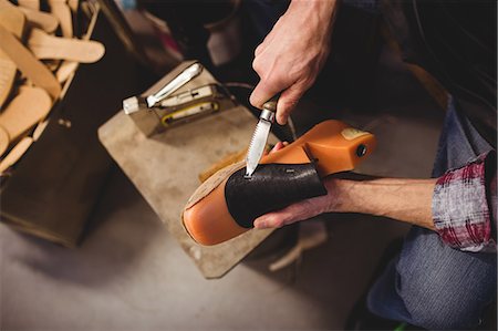 simsearch:6109-08582278,k - Overhead of cobbler using a knife on a shoe Stock Photo - Premium Royalty-Free, Code: 6109-08582269