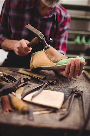 simsearch:6109-08582278,k - Cobbler hammering on a shoe Stock Photo - Premium Royalty-Free, Code: 6109-08582280