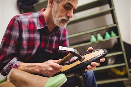 simsearch:6109-08582278,k - Cobbler hammering on the sole of a shoe Stock Photo - Premium Royalty-Free, Code: 6109-08582286