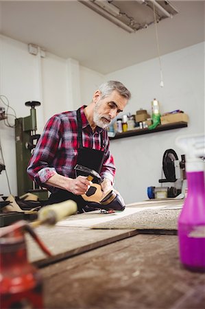 simsearch:6109-08582278,k - Cobbler hammering on the heel of a shoe Stock Photo - Premium Royalty-Free, Code: 6109-08582224