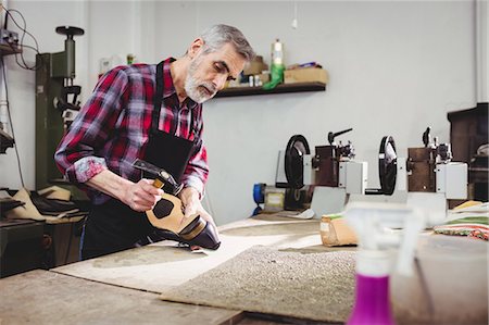 simsearch:6109-08582278,k - Cobbler hammering on the heel of a shoe Stock Photo - Premium Royalty-Free, Code: 6109-08582225