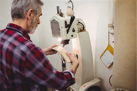 simsearch:6109-08582278,k - Side view of cobbler using a sewing machine Stock Photo - Premium Royalty-Free, Code: 6109-08582230