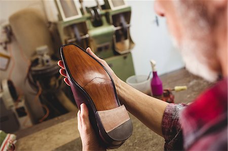 simsearch:6109-08582278,k - Close up of cobbler examining the sole of a shoe Stock Photo - Premium Royalty-Free, Code: 6109-08582238