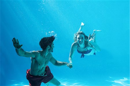 swimming pool villa - Happy couple swimming underwater Stock Photo - Premium Royalty-Free, Code: 6109-08536465