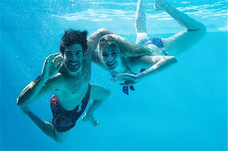 swimming pool villa - Happy couple swimming underwater Stock Photo - Premium Royalty-Free, Code: 6109-08536466