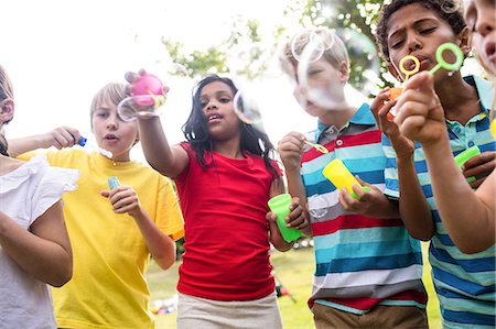 Children blowing bubbles wand in the park Photographie de stock - Premium Libres de Droits, Code: 6109-08536429