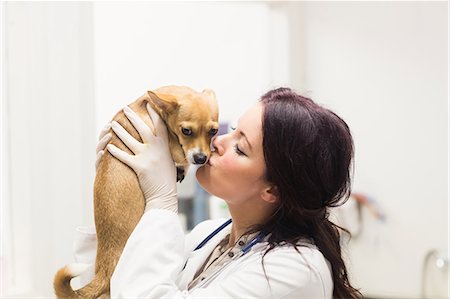 simsearch:6109-08537861,k - Veterinarian kissing a dog Stock Photo - Premium Royalty-Free, Code: 6109-08536654