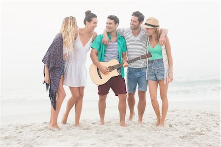 simsearch:6109-06781569,k - Cute group of friends playing the guitar Stock Photo - Premium Royalty-Free, Code: 6109-08536881