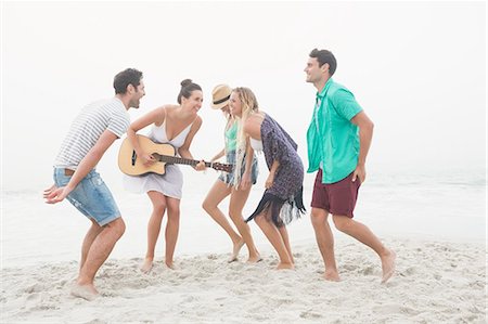 simsearch:6109-06781569,k - Cute group of friends playing the guitar Stock Photo - Premium Royalty-Free, Code: 6109-08536882
