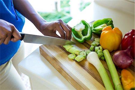 simsearch:6109-08390293,k - Mid-section of woman chopping vegetable in kitchen Stock Photo - Premium Royalty-Free, Code: 6109-08537098