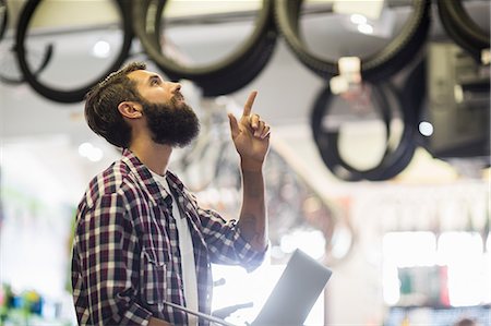 Bike mechanic checking laptop Foto de stock - Sin royalties Premium, Código: 6109-08537235