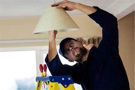 step ladder - Electrician repairing a ceiling lamp Stock Photo - Premium Royalty-Free, Code: 6109-08537530