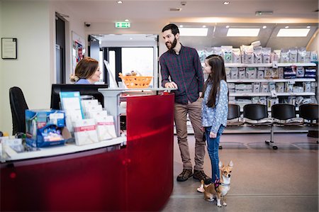 simsearch:6109-08537861,k - Father and daughter standing with dog at counter Stock Photo - Premium Royalty-Free, Code: 6109-08537845