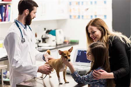 simsearch:6109-08537861,k - Vet examining a dog with its owner Stock Photo - Premium Royalty-Free, Code: 6109-08537866