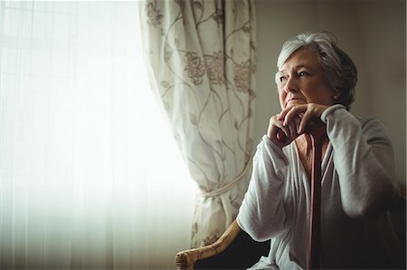 female elderly - Thoughtful senior woman sitting on a chair Stock Photo - Premium Royalty-Free, Code: 6109-08538285