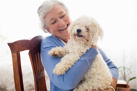 retirement concept - Senior woman holding a dog Stock Photo - Premium Royalty-Free, Code: 6109-08538237