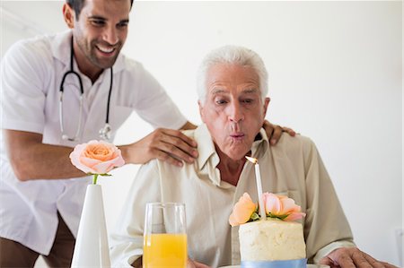 elderly assisted living - Senior man celebrating his birthday with a cake Stock Photo - Premium Royalty-Free, Code: 6109-08538353