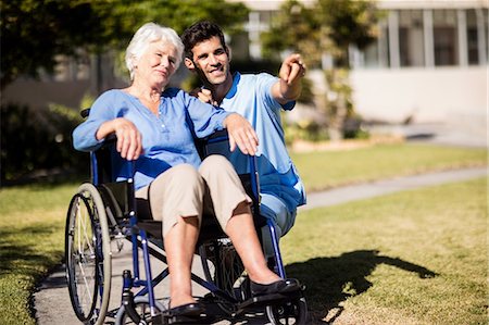 elderly woman posing - Nurse pushing the senior womans Zimmer frame Stock Photo - Premium Royalty-Free, Code: 6109-08538449