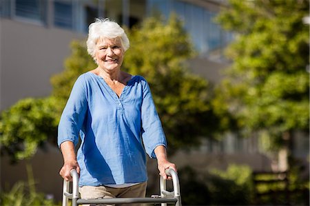 retirement concept - Senior woman posing with her Zimmer Frame Stock Photo - Premium Royalty-Free, Code: 6109-08538454