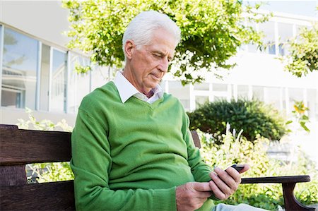 senior healthcare - Senior man texting someone Stock Photo - Premium Royalty-Free, Code: 6109-08538460