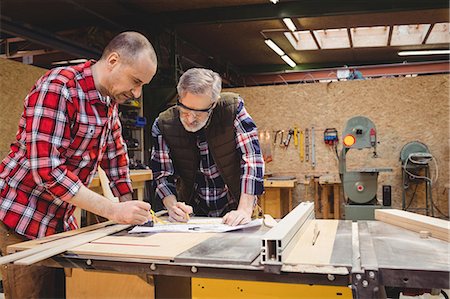 Carpenters reading a work plan in carpentry Stock Photo - Premium Royalty-Free, Code: 6109-08689550