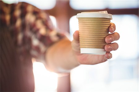 service counter - Waiter offering a cup of coffee at cafe Stock Photo - Premium Royalty-Free, Code: 6109-08689766