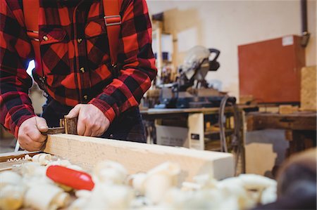 simsearch:6102-07158067,k - Carpenter working on wood plank in his workshop Stock Photo - Premium Royalty-Free, Code: 6109-08689713