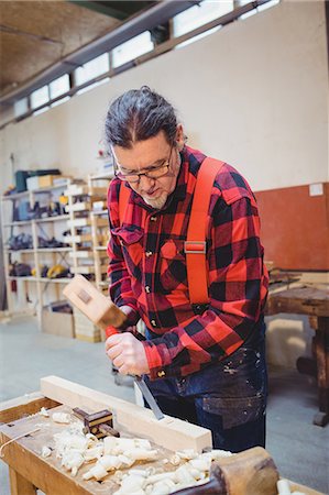 simsearch:6102-07158067,k - Carpenter working on a wooden plan with an hammer in his workplace Stock Photo - Premium Royalty-Free, Code: 6109-08689715