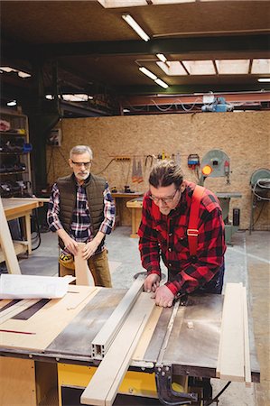 simsearch:6102-07158067,k - Duo of carpenter working on a wood plank in their workshop Stock Photo - Premium Royalty-Free, Code: 6109-08689723