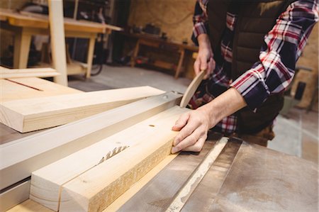 simsearch:6102-07158067,k - Focus on worker cutting a plank of wood in his workshop Stock Photo - Premium Royalty-Free, Code: 6109-08689727