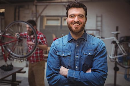 Portrait of man mechanic smiling with his arms crossed Stock Photo - Premium Royalty-Free, Code: 6109-08689891