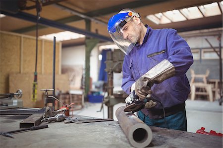 repairman - Man working on a metal work in workshop Stock Photo - Premium Royalty-Free, Code: 6109-08689825