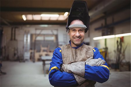 Portrait of welder smiling in workshop Stock Photo - Premium Royalty-Free, Code: 6109-08689949