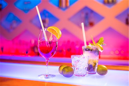 Glasses of drink on counter in nightclub Stock Photo - Premium Royalty-Free, Code: 6109-08690533