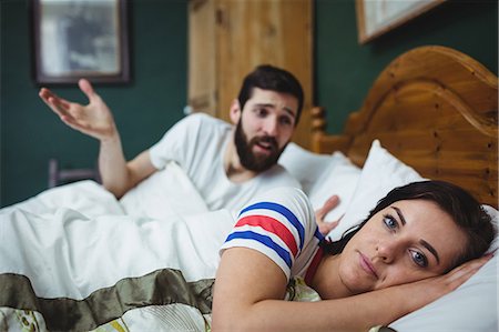 simsearch:6109-07601529,k - Couple arguing on bed in bedroom at home Stock Photo - Premium Royalty-Free, Code: 6109-08763904