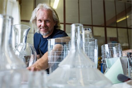 Portrait of glassblower working on a glass at glassblowing factory Stock Photo - Premium Royalty-Free, Code: 6109-08764111