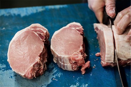 fresh meat - Hand of butcher slicing meat at butchers shop Stock Photo - Premium Royalty-Free, Code: 6109-08764550