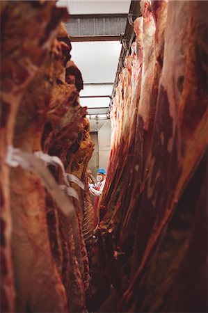 Peeled red meat hanging in the storage room at butchers shop Stock Photo - Premium Royalty-Free, Code: 6109-08764519