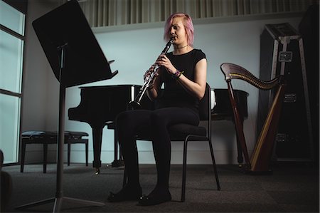 Beautiful woman playing a clarinet in music school Stock Photo - Premium Royalty-Free, Code: 6109-08764713