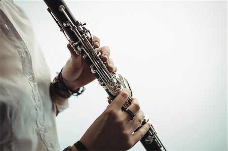 Mid-section of woman playing a clarinet in music school Stock Photo - Premium Royalty-Free, Code: 6109-08764732