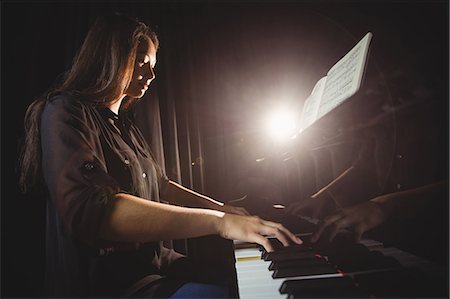 Female student playing piano in a studio Stock Photo - Premium Royalty-Free, Code: 6109-08764942