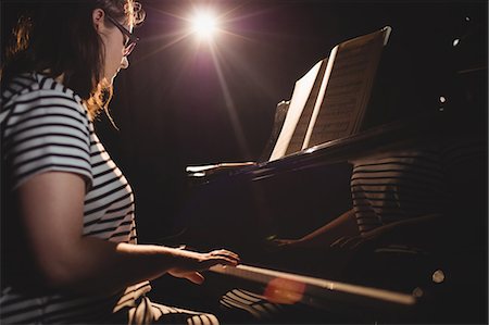 Female student playing piano in a studio Stock Photo - Premium Royalty-Free, Code: 6109-08764947