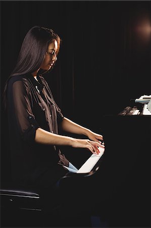 Female student playing piano in a studio Stock Photo - Premium Royalty-Free, Code: 6109-08764999