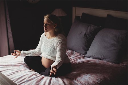 simsearch:400-06872329,k - Pregnant woman performing yoga in bedroom at home Stock Photo - Premium Royalty-Free, Code: 6109-08764902