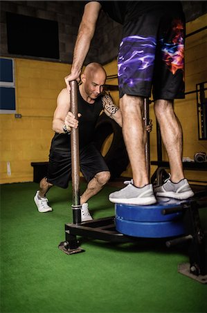 simsearch:649-07238777,k - Thai boxers practicing weight exercise in the fitness studio Stock Photo - Premium Royalty-Free, Code: 6109-08765041
