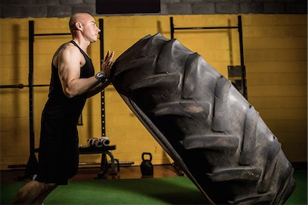 simsearch:693-08126938,k - Thai boxer lifting heavy tyre in the fitness studio Stock Photo - Premium Royalty-Free, Code: 6109-08765044