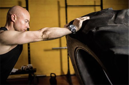 simsearch:649-07238777,k - Thai boxer lifting heavy tyre in the fitness studio Stock Photo - Premium Royalty-Free, Code: 6109-08765045