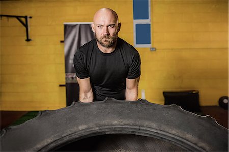 simsearch:649-07238777,k - Thai boxer lifting heavy tyre in the fitness studio Stock Photo - Premium Royalty-Free, Code: 6109-08765046