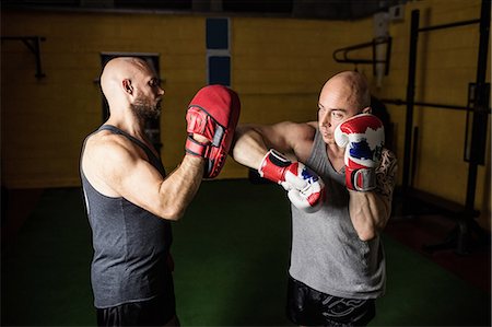 simsearch:400-03984387,k - Thai boxers practicing boxing in the fitness studio Stock Photo - Premium Royalty-Free, Code: 6109-08765067